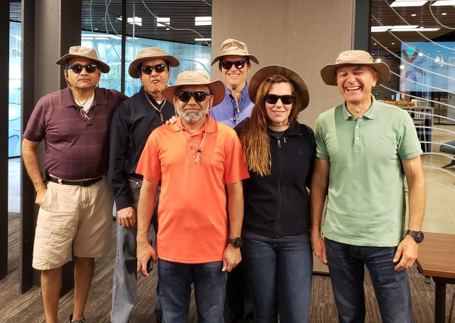 6 people in hats, smiling for camera